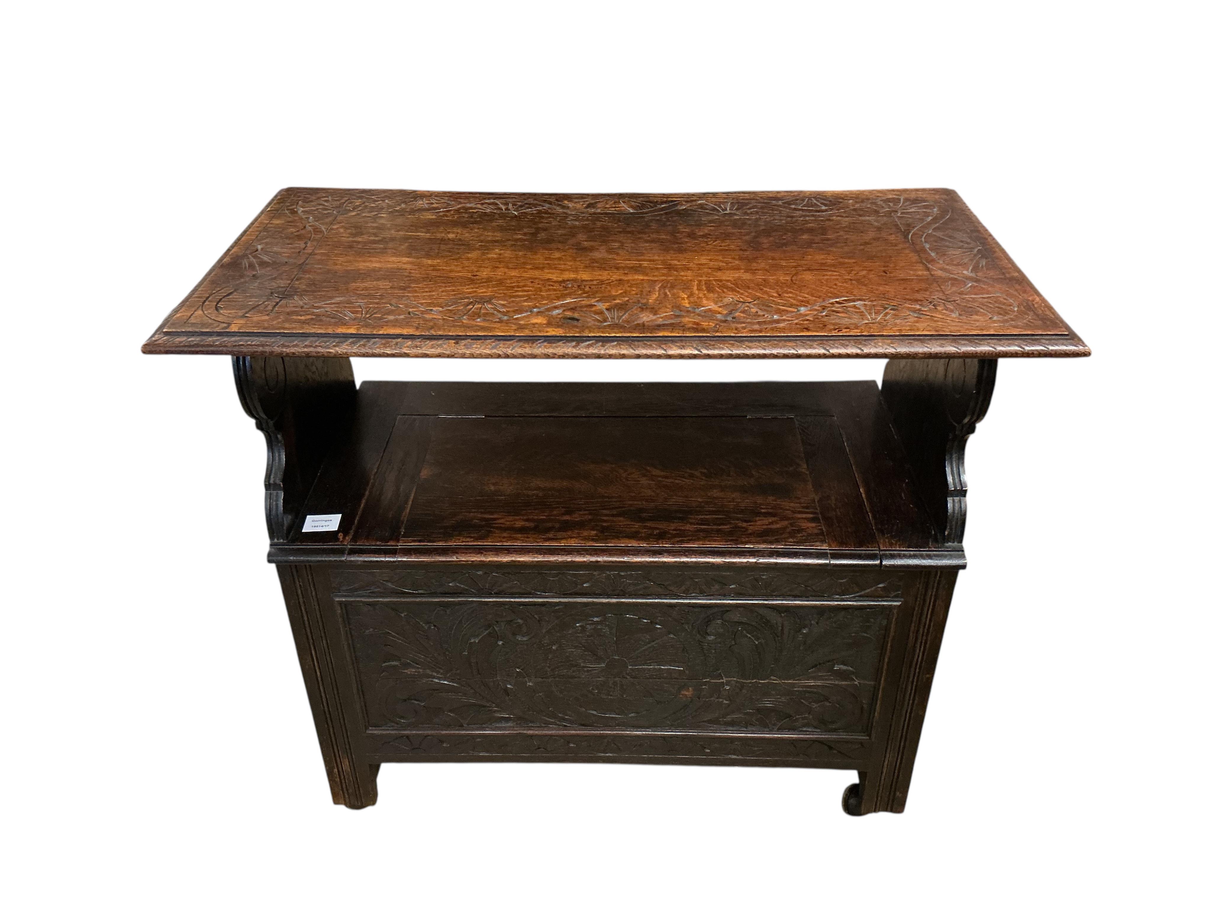 A small 1920's oak monk's bench, width 91cm, depth 46cm, height 106cm